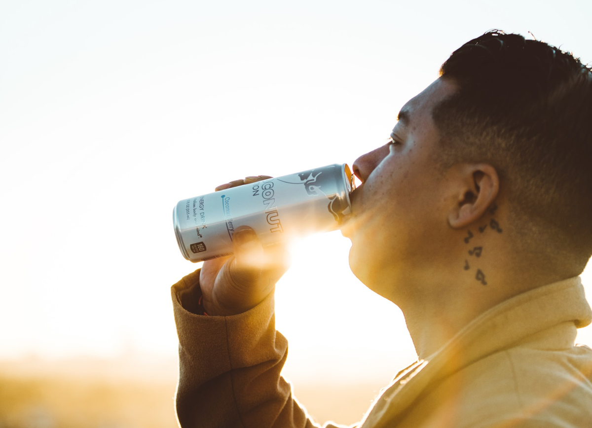 A man sips an energy drink.